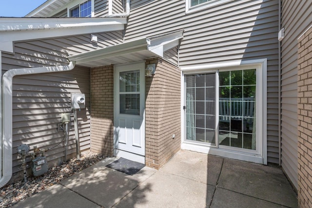 8379 Corcoran Cir Unit 47, Inver Grove Heights, MN 55076 - property entrance featuring brick siding and a patio area
