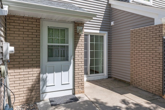 8379 Corcoran Cir Unit 47, Inver Grove Heights, MN 55076 - property entrance with brick siding and a shingled roof