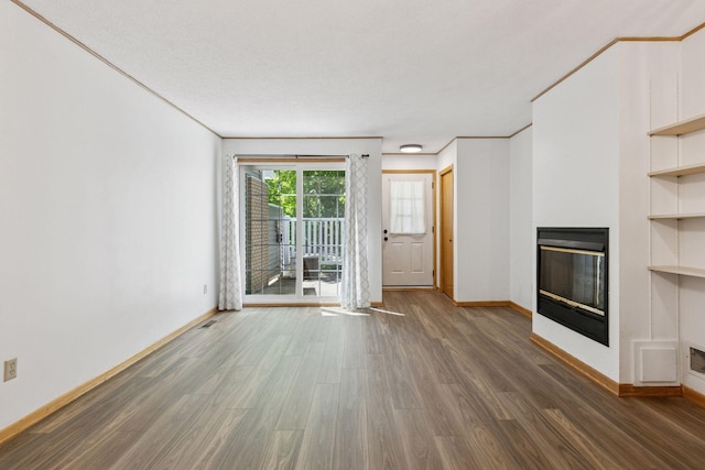 8379 Corcoran Cir Unit 47, Inver Grove Heights, MN 55076 - unfurnished living room with a glass covered fireplace, wood finished floors, baseboards, ornamental molding, and built in features