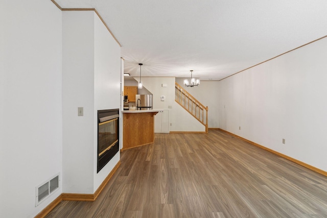 8379 Corcoran Cir Unit 47, Inver Grove Heights, MN 55076 - unfurnished living room with light wood-style flooring, baseboards, and a chandelier