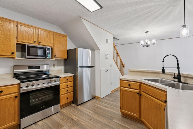 8379 Corcoran Cir Unit 47, Inver Grove Heights, MN 55076 - kitchen with stainless steel appliances, a sink, light wood-style floors, light countertops, and a textured ceiling