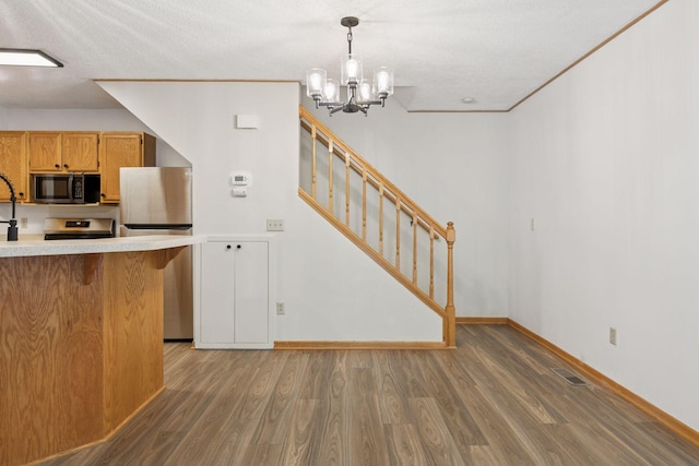 8379 Corcoran Cir Unit 47, Inver Grove Heights, MN 55076 - kitchen featuring stainless steel microwave, wood finished floors, light countertops, refrigerator, and a chandelier