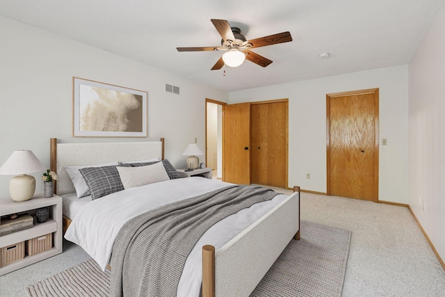 8379 Corcoran Cir Unit 47, Inver Grove Heights, MN 55076 - bedroom featuring light colored carpet, baseboards, a ceiling fan, and two closets