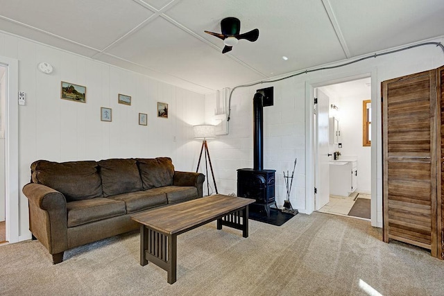 10777 70th St, Clear Lake, MN 55319 - living room featuring a wood stove, ceiling fan, and light carpet