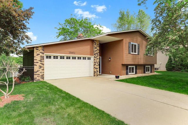 10432 102nd Pl, Maple Grove, MN 55369 - view of front of house with driveway, an attached garage, a front yard, brick siding, and a chimney