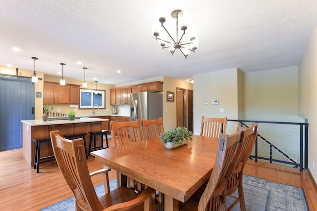10432 102nd Pl, Maple Grove, MN 55369 - dining room featuring a chandelier, light wood-type flooring, recessed lighting, and a textured ceiling