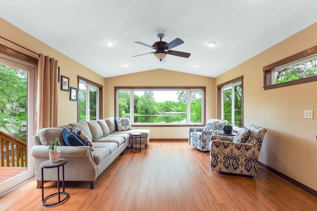 10432 102nd Pl, Maple Grove, MN 55369 - living room with lofted ceiling, healthy amount of natural light, a ceiling fan, light wood finished floors, and baseboards