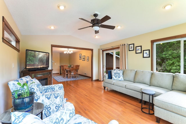 10432 102nd Pl, Maple Grove, MN 55369 - living room with vaulted ceiling, light wood finished floors, a chandelier, and ceiling fan