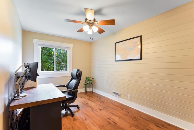 10432 102nd Pl, Maple Grove, MN 55369 - home office featuring baseboards, wooden walls, light wood-style flooring, and a ceiling fan