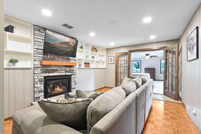10432 102nd Pl, Maple Grove, MN 55369 - living area with a stone fireplace, wood walls, a ceiling fan, and recessed lighting