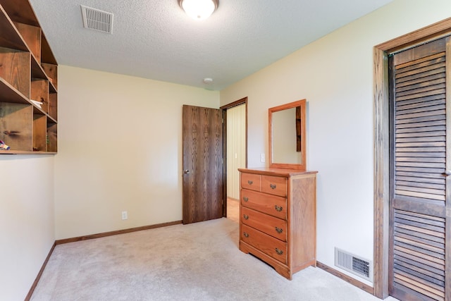 10432 102nd Pl, Maple Grove, MN 55369 - bedroom with light colored carpet, a textured ceiling, and baseboards
