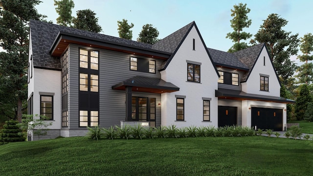 view of front of house featuring an attached garage and a front yard