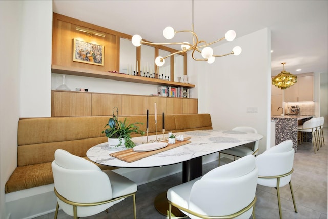 dining space with a chandelier and light tile patterned flooring