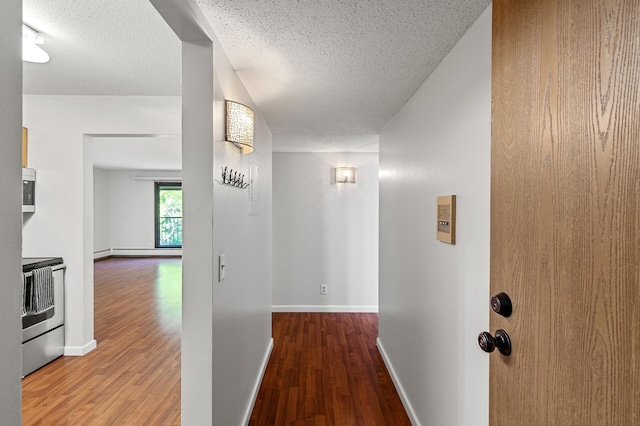 10441 Greenbrier Rd Unit 315, Minnetonka, MN 55305 - hallway with wood finished floors, a textured ceiling, a baseboard heating unit, and baseboards