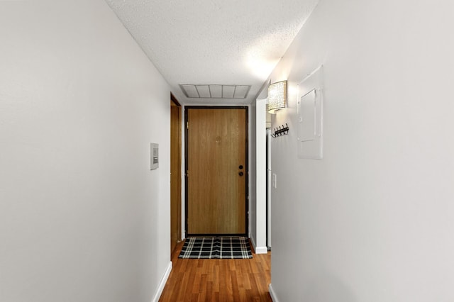 10441 Greenbrier Rd Unit 315, Minnetonka, MN 55305 - hallway with wood finished floors, a textured ceiling, baseboards, and electric panel