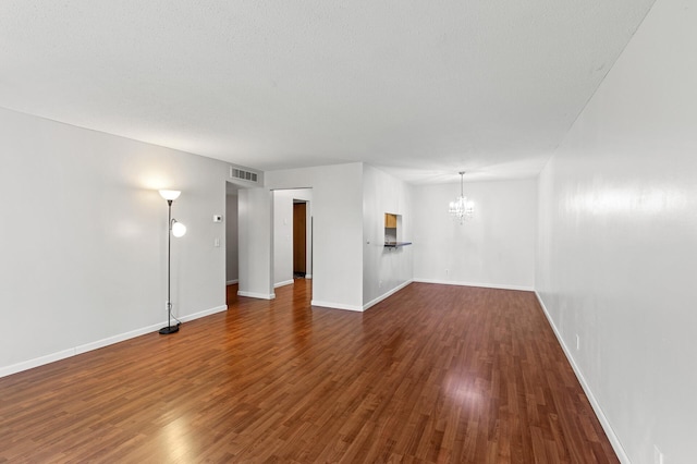 10441 Greenbrier Rd Unit 315, Minnetonka, MN 55305 - empty room featuring a chandelier, baseboards, and dark wood-style flooring