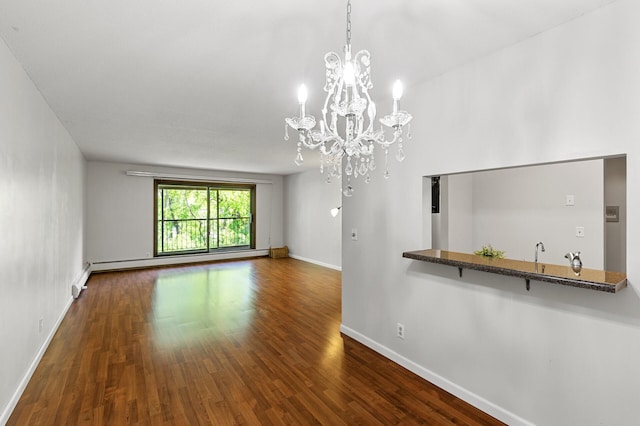 10441 Greenbrier Rd Unit 315, Minnetonka, MN 55305 - unfurnished living room featuring wood finished floors, baseboards, baseboard heating, a chandelier, and a baseboard radiator
