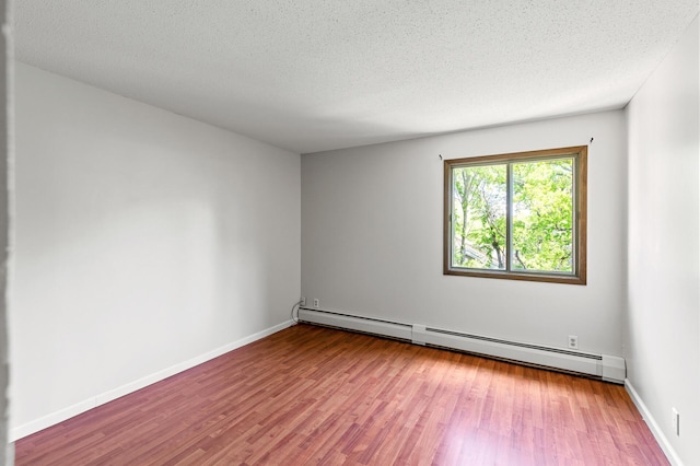 10441 Greenbrier Rd Unit 315, Minnetonka, MN 55305 - empty room featuring a baseboard radiator, wood finished floors, a textured ceiling, and baseboards