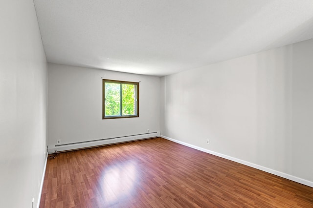 10441 Greenbrier Rd Unit 315, Minnetonka, MN 55305 - spare room featuring a baseboard heating unit, wood finished floors, and baseboards