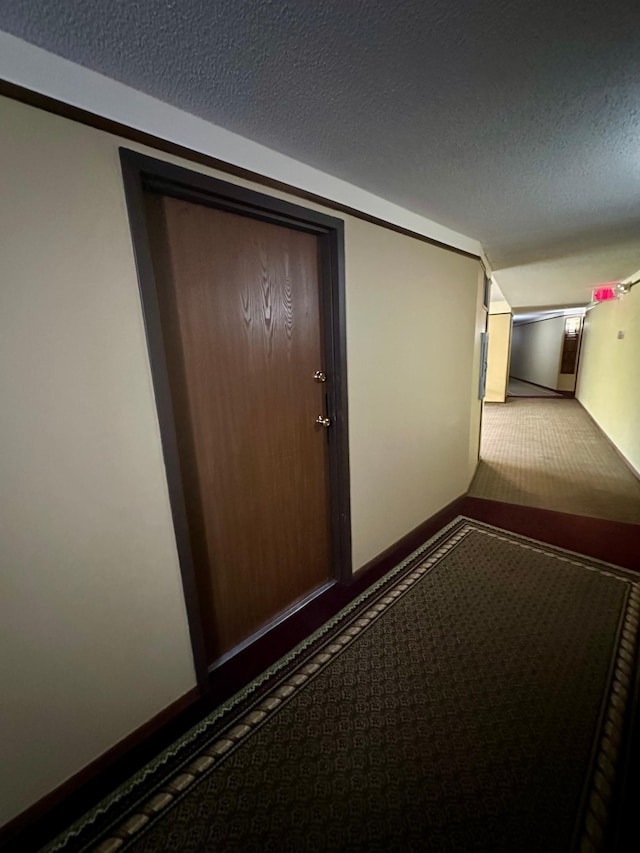 10441 Greenbrier Rd Unit 315, Minnetonka, MN 55305 - corridor with a textured ceiling, baseboards, and carpet floors