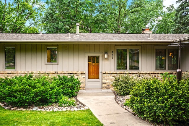 451 Reflection Rd, Apple Valley, MN 55124 - view of front of property featuring brick siding, roof with shingles, board and batten siding, and a chimney