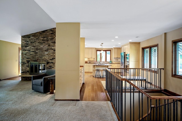 451 Reflection Rd, Apple Valley, MN 55124 - hall with an upstairs landing, light wood-style flooring, recessed lighting, and light colored carpet
