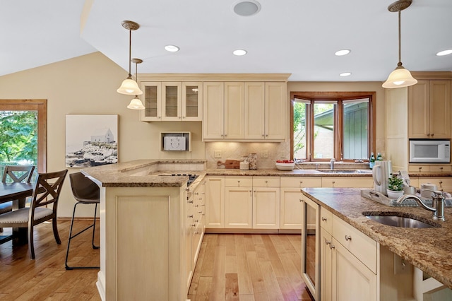 451 Reflection Rd, Apple Valley, MN 55124 - kitchen featuring a peninsula, light wood-type flooring, glass insert cabinets, tasteful backsplash, and recessed lighting