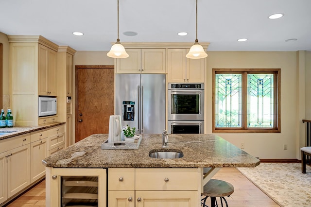 451 Reflection Rd, Apple Valley, MN 55124 - kitchen with stainless steel appliances, cream cabinetry, beverage cooler, light stone countertops, and recessed lighting