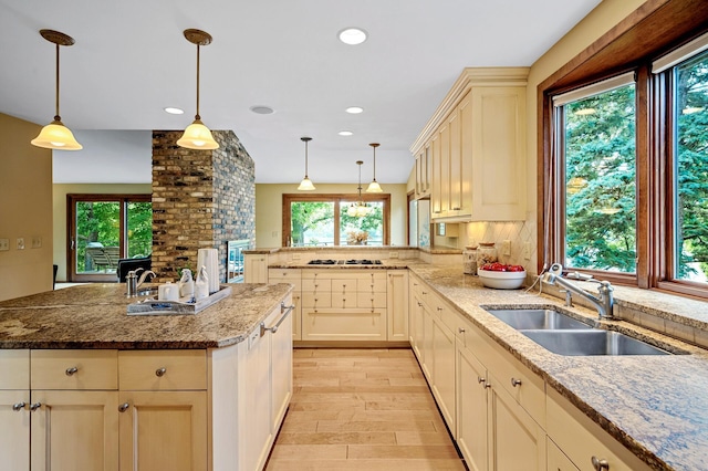 451 Reflection Rd, Apple Valley, MN 55124 - kitchen featuring a peninsula, light wood-style floors, light stone counters, pendant lighting, and recessed lighting