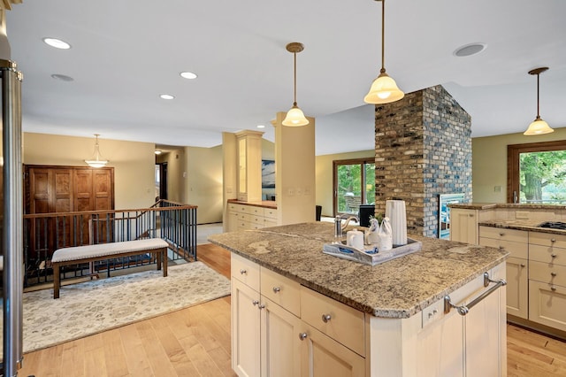 451 Reflection Rd, Apple Valley, MN 55124 - kitchen featuring light wood-style flooring, a center island, light stone countertops, decorative light fixtures, and recessed lighting