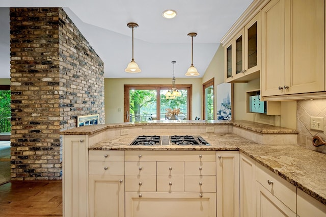 451 Reflection Rd, Apple Valley, MN 55124 - kitchen with stainless steel gas stovetop, lofted ceiling, a peninsula, cream cabinetry, and wood finished floors