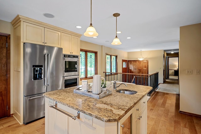 451 Reflection Rd, Apple Valley, MN 55124 - kitchen with stainless steel appliances, light wood-type flooring, light stone countertops, decorative light fixtures, and a kitchen island with sink