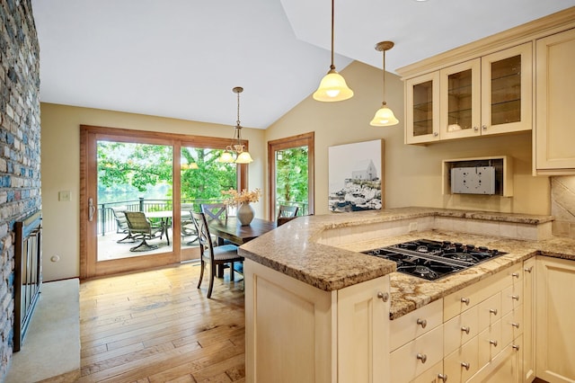 451 Reflection Rd, Apple Valley, MN 55124 - kitchen featuring black gas stovetop, a peninsula, plenty of natural light, glass insert cabinets, and vaulted ceiling
