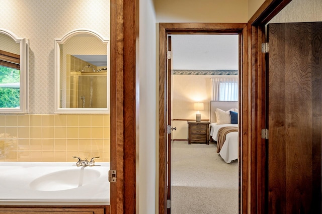 451 Reflection Rd, Apple Valley, MN 55124 - ensuite bathroom featuring wallpapered walls, healthy amount of natural light, and vanity