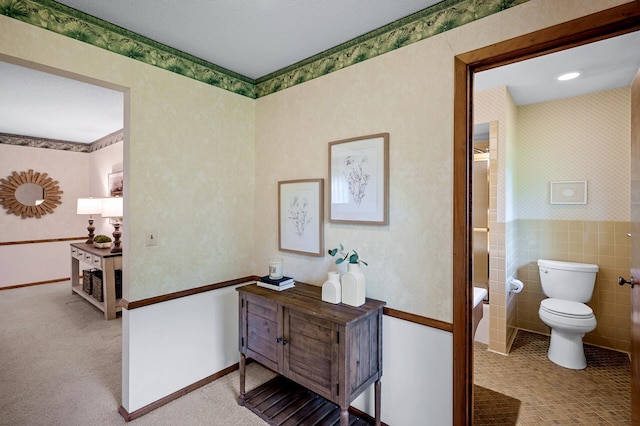 451 Reflection Rd, Apple Valley, MN 55124 - hallway featuring tile walls, wainscoting, and wallpapered walls