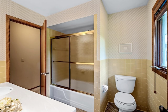 451 Reflection Rd, Apple Valley, MN 55124 - full bath with wallpapered walls, tile walls, enclosed tub / shower combo, wainscoting, and healthy amount of natural light