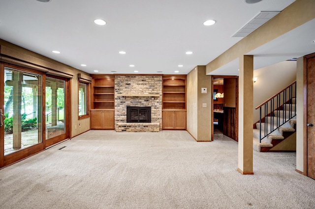 451 Reflection Rd, Apple Valley, MN 55124 - unfurnished living room featuring a fireplace, light colored carpet, recessed lighting, stairs, and built in shelves
