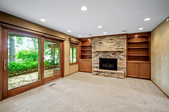 451 Reflection Rd, Apple Valley, MN 55124 - unfurnished living room featuring recessed lighting, light colored carpet, built in shelves, and a brick fireplace