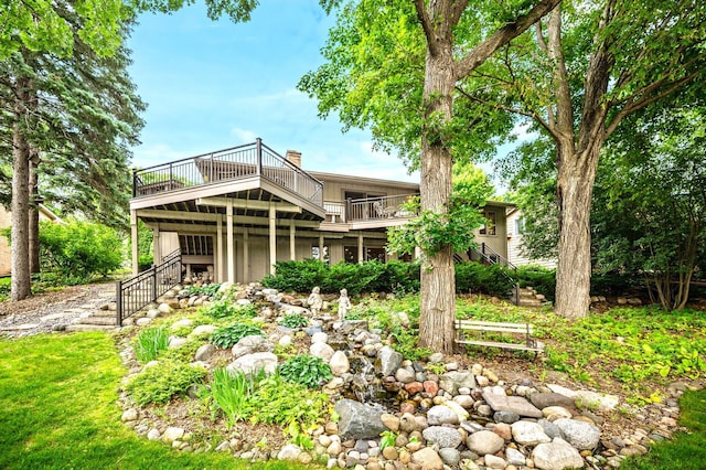 451 Reflection Rd, Apple Valley, MN 55124 - back of house featuring stairs, a wooden deck, and a chimney
