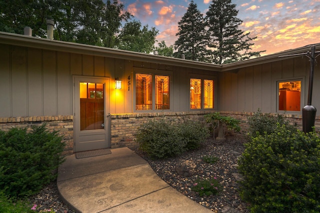 451 Reflection Rd, Apple Valley, MN 55124 - exterior entry at dusk with board and batten siding