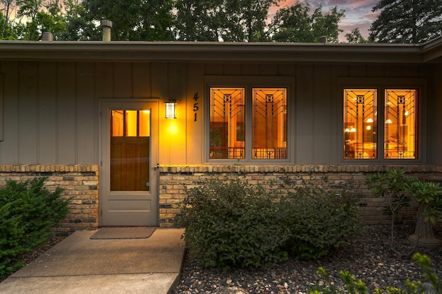 451 Reflection Rd, Apple Valley, MN 55124 - exterior entry at dusk featuring brick siding and board and batten siding
