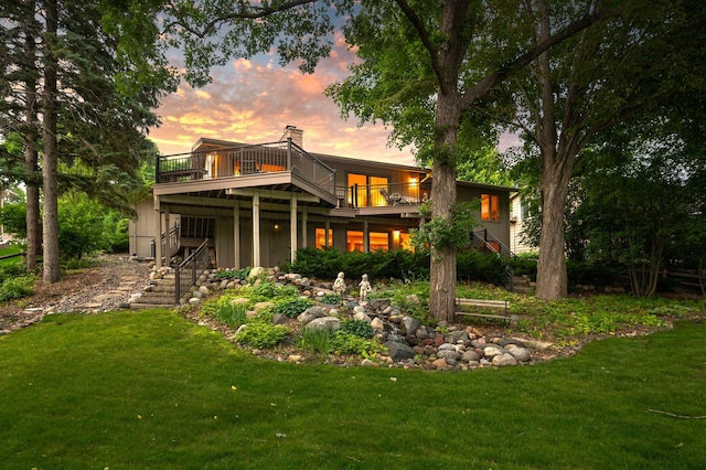 451 Reflection Rd, Apple Valley, MN 55124 - rear view of house with a deck, stairway, and a lawn