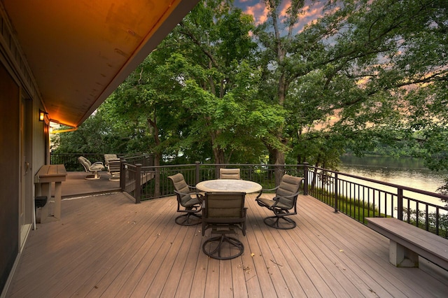 451 Reflection Rd, Apple Valley, MN 55124 - deck at dusk featuring a water view and outdoor dining space