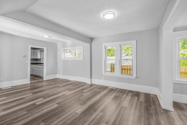 1912 15th Ave N, Minneapolis, MN 55411 - empty room with wood finished floors, a textured ceiling, and baseboards