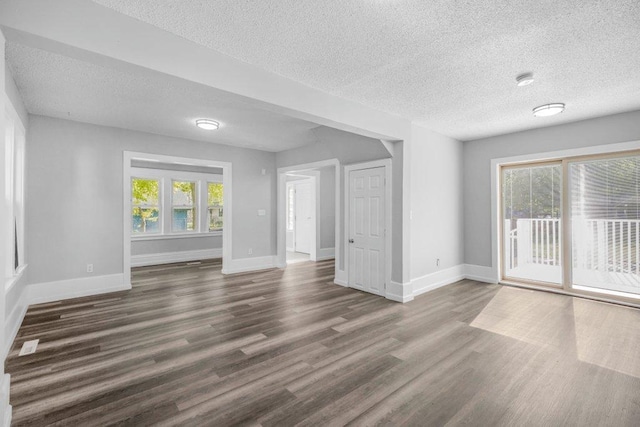 1912 15th Ave N, Minneapolis, MN 55411 - unfurnished room featuring a textured ceiling, wood finished floors, and baseboards