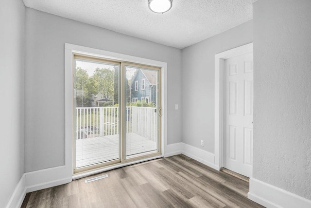 1912 15th Ave N, Minneapolis, MN 55411 - entryway with a textured ceiling, wood finished floors, and baseboards