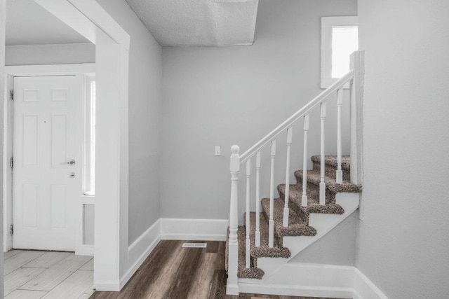 1912 15th Ave N, Minneapolis, MN 55411 - foyer entrance with wood finished floors, stairway, and baseboards