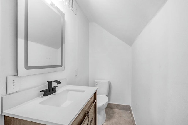 1912 15th Ave N, Minneapolis, MN 55411 - bathroom with toilet, vanity, vaulted ceiling, and baseboards