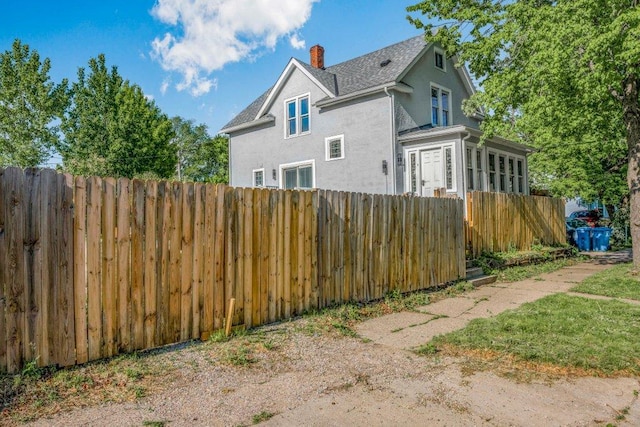 1912 15th Ave N, Minneapolis, MN 55411 - view of side of home with stucco siding and a chimney