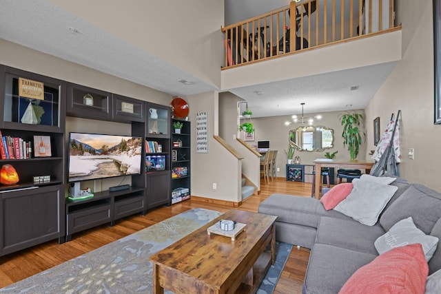 367 Ojibway Path, Lino Lakes, MN 55014 - living room with wood finished floors, stairs, and a chandelier